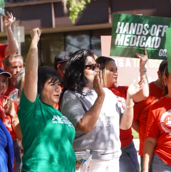 Photo of AFSCME Local 4041 member Rosina Barrientos with hand raised in a fist