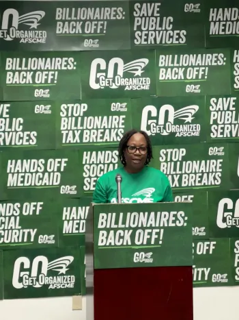 AFSCME Member Yolanda Kemp in a green AFSCME shirt speaking at a podium