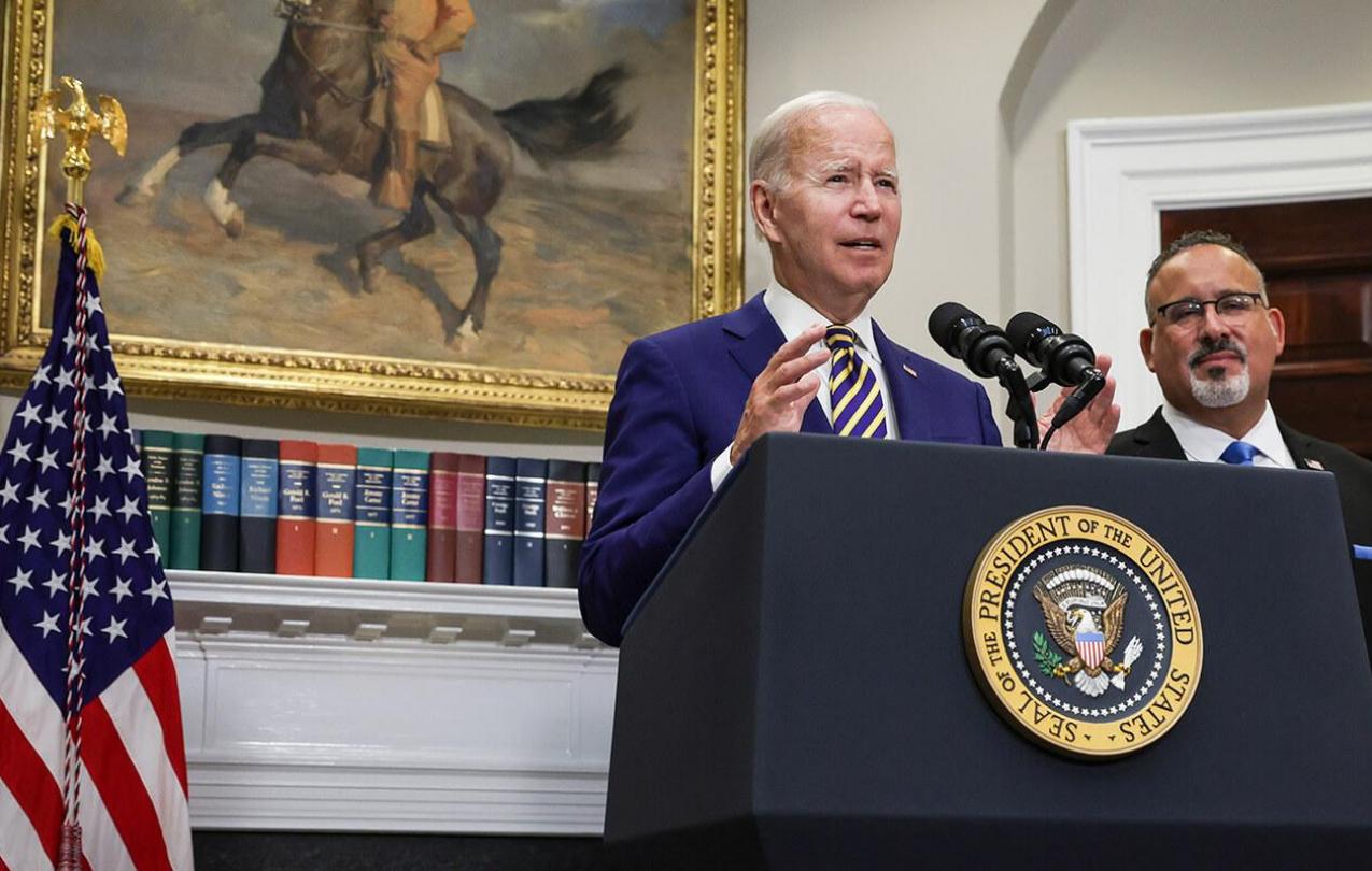 President Joe Biden, joined by Education Secretary Miguel Cardona, speaks on student loan debt in the Roosevelt Room of the White House. Photo credit: Alex Wong/Getty Images